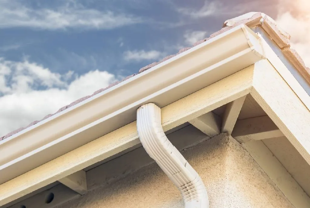 Gutter repair and re-pitching on a metal roof in NWA