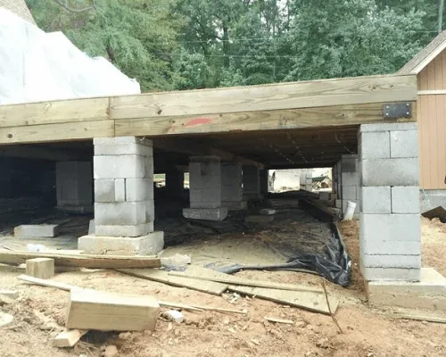 Crew inspecting foundation in Northwest Arkansas